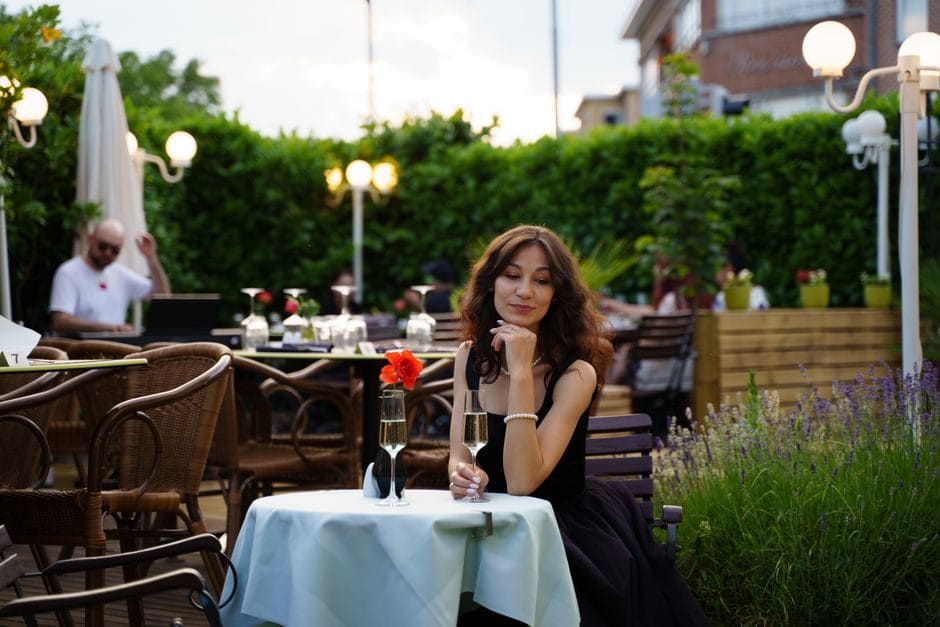 A woman sitting calmly in a garden in the evening summer light